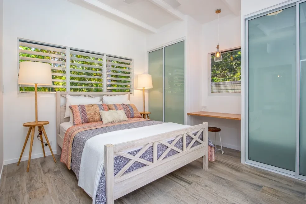 42 HL — master bedroom with white timber bedhead, louvre windows and ensuite