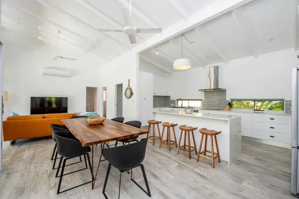 42 HL — open-plan dining and kitchen with timber table and raked ceiling