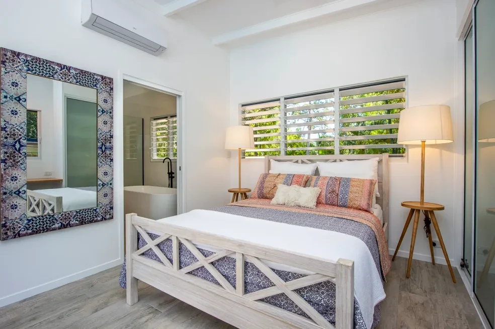 42 HL — second bedroom with louvre windows and ensuite beyond