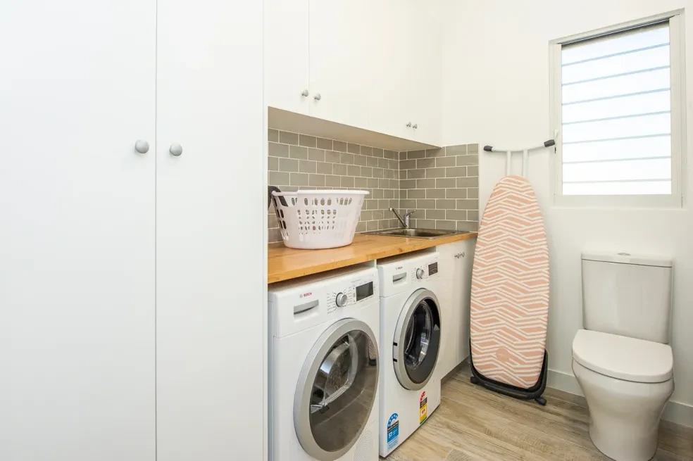42 HL — laundry with subway tile splashback, timber benchtop and louvre window