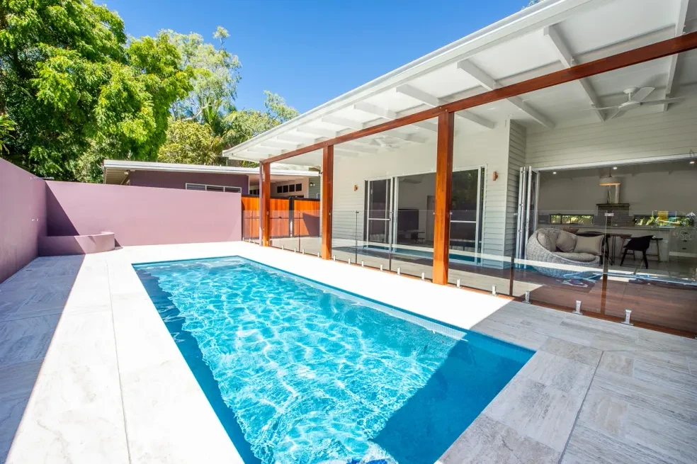 42 HL — covered deck with wicker chair and pool beyond