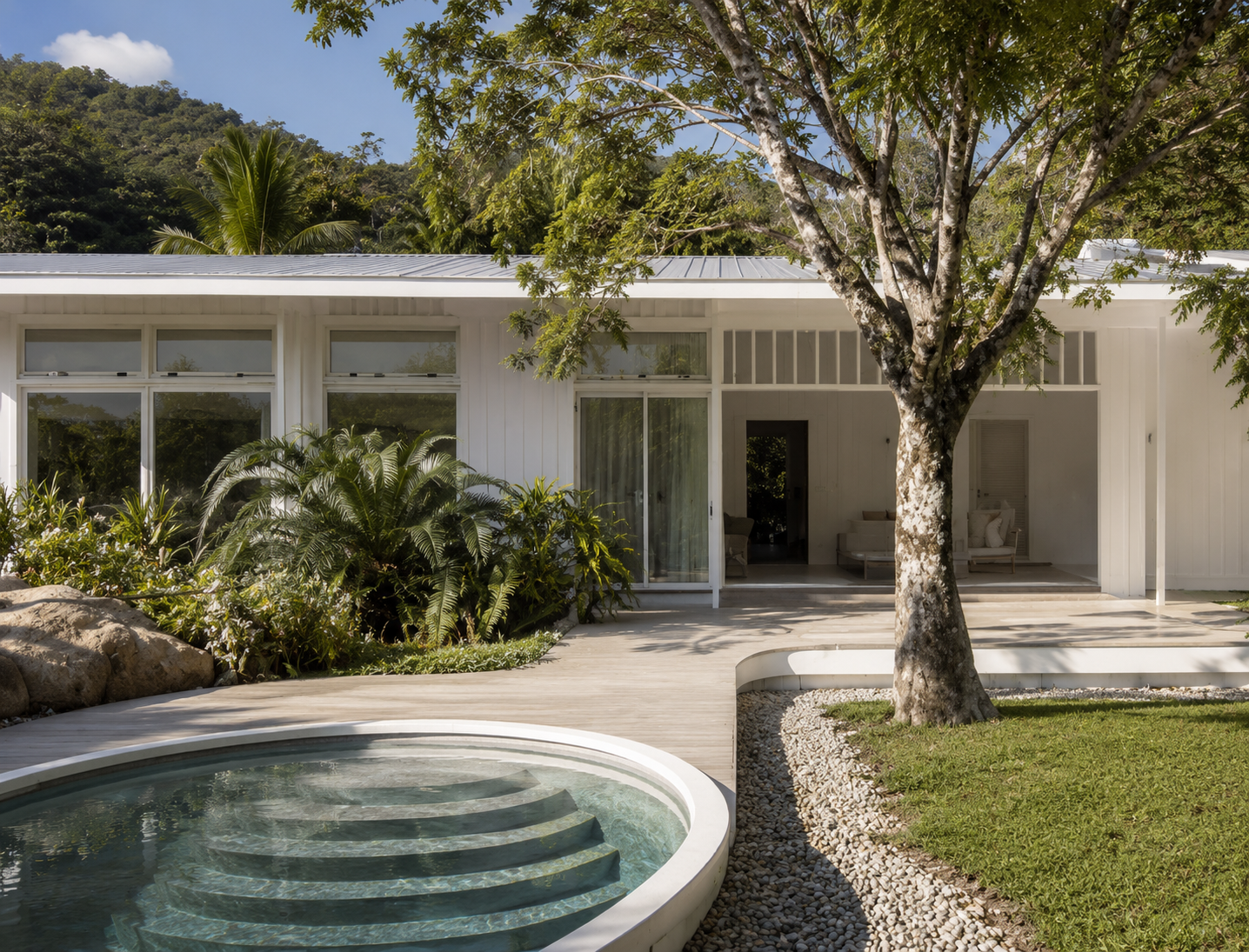 Bush Retreat — completed front elevation with circular pool, timber deck, mature tree and tropical planting