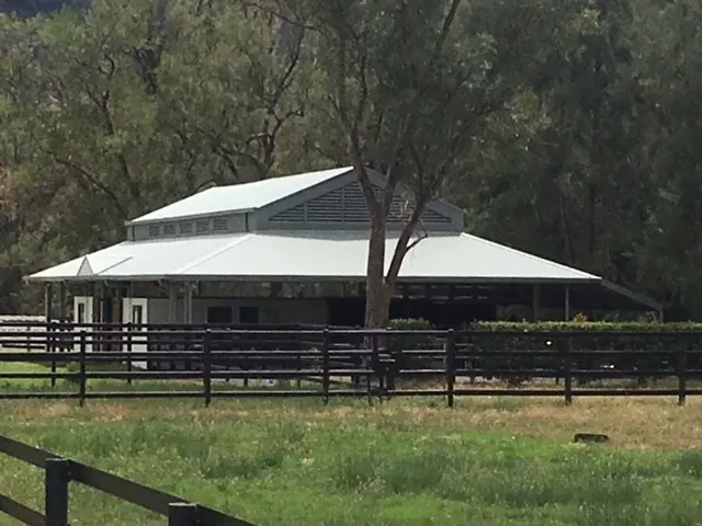 Stable — octagonal stable building with hip roof and black fencing